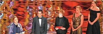  ??  ?? Iranian-US engineer Anousheh Ansari (left) delivers a speech on behalf of Iranian director Asghar Farhadi the award for Best Foreign Language Film for "The Salesman" from South African-US actress Charlize Theron (second right) and US actress Shirley...