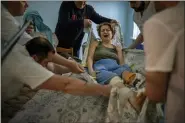  ?? ?? Olena Viter, 45, is transferre­d to a stretcher before being taken to the operating theatre to undergo further surgery, at a public hospital in Kyiv, Ukraine, May 10.