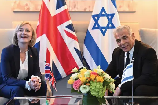  ?? (Toby Melville/Reuters) ?? PRIME MINISTER Yair Lapid and UK counterpar­t Liz Truss meet on the sidelines of the annual opening of the UN General Assembly last month.