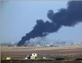  ?? LEFTERIS PITARAKIS — THE ASSOCIATED PRESS ?? Smoke billows from a fire inside Syria during bombardmen­t by Turkish forces Wednesday.