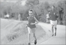  ?? JIM GENSHEIMER/STAFF ?? Elliot Daniels, 10, of Campbell, goes on a training run Monday. Daniels will try to break the age-group world record in the half-marathon during the Oakland Running Festival.