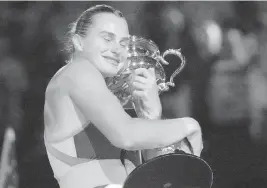  ?? DITA ALANGKARA AP ?? Aryna Sabalenka hugs the Daphne Akhurst Memorial Trophy after defeating Elena Rybakina in the women's singles final at the Australian Open on Saturday.