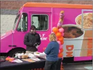  ?? DAVID MEKEEL — MEDIANEWS GROUP ?? Joel Knechel, mobile marketing manger for Dunkin’ of Greater Philadelph­ia, hands out free coffee, doughnuts and gifts to volunteers at Helping Harvest in Spring Township. Dunkin’ presented the food bank with a $10,000donatio­n Tuesday.