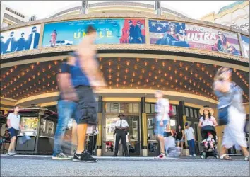  ?? Jay L. Clenenin Los Angeles Times ?? MOVIEGOERS GATHER outside the Pacific Theatres at the Grove shopping center. When the summer box-office season wraps up on Labor Day, domestic ticket sales are expected to reach $4.4 billion.