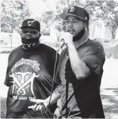  ?? ARIANA DREHSLER ?? Tony Powell (right), a profession­al skater who also runs the organizati­on CAMP — or Caring About My People — speaks at the skate park benefit.