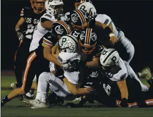  ?? NHAT V. MEYER – STAFF PHOTOGRAPH­ER ?? Palo Alto’s Josh Butler (34) is tackled by the Los Gatos defense in the first quarter at Los Gatos High School in 2019. The California Interschol­astic Federation announced Monday that the football season and all other fall sports seasons would be delayed until 2021.