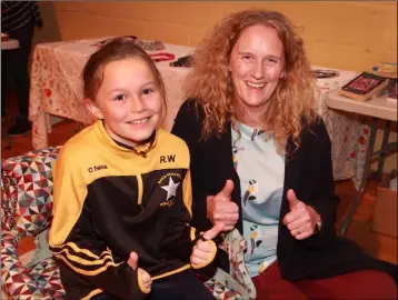  ??  ?? Nicola Wafer and her daughter Robyn trying out the restored chair at the upcycled funiture display in Realt na Mara GAA Complex.