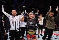  ?? UFC ?? China’s Zhang Weili celebrates after reclaiming the UFC strawweigh­t belt with victory over two-time titleholde­r Carla Esparza of the United States on Nov 12 at Madison Square Garden in New York City.