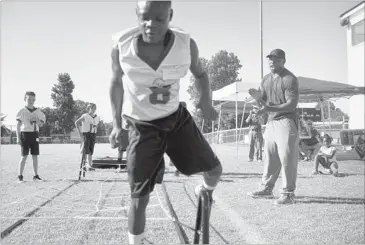  ?? BRANDON DILL/SPECIAL TO THE COMMERCIAL APPEAL ?? NFL running back and Horn Lake High School alumnus Brandon Jackson cheers on Michael Daughiry as he works through an obstacle course at Jackson’s camp at Latimer Lakes Park in Horn Lake.