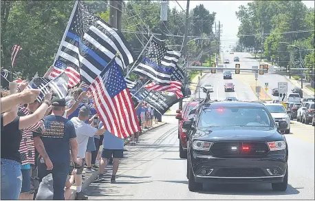  ?? PHOTOS BY PETE BANNAN - MEDIANEWS GROUP ?? Police supporters wave flags to police at the ‘Back the Blue’ rally along MacDade Boulevard in Ridley on Sunday.