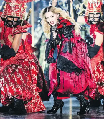  ?? RICH FURY/THE ASSOCIATED PRESS ?? Madonna, seen on stage in 2015 during her Rebel Heart Tour, made ambitious costume changes, revolution­ary lighting and complicate­d dance routines her signature.