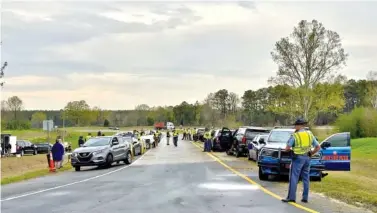  ?? JOE KOVAC JR./ATLANTA JOURNAL-CONSTITUTI­ON ?? Police set up at an exit southeast of Macon along I-16 in Twiggs County last weekend during the annual St. Patrick’s Day license check and sobriety checkpoint.
