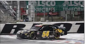  ?? (AP/Gerry Broome) ?? Kyle Busch crosses the finish line to win the NASCAR Xfinity Series race Monday night in Concord, N.C. Busch passed Austin Cindric on the final lap to take the lead.