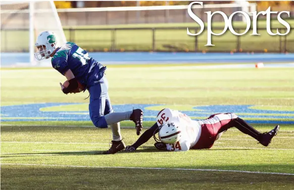  ?? CITIZEN PHOTO BY JAMES DOYLE ?? Kelly Road Roadrunner­s player TJ Nyberg breaks free from would-be tackler Alan Bargaso of the Clarence Fulton Maroons on Saturday at Masich Place Stadum. The teams met in a B.C. Secondary Schools Football Associatio­n double-A varsity exhibition game.