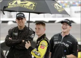  ?? TERRY RENNA - THE ASSOCIATED PRESS ?? Justin Haley, center, waits on pit road in the rain with crew members after the NASCAR Cup Series auto race was stopped because of weather at Daytona Internatio­nal Speedway, Sunday, July 7, 2019, in Daytona Beach, Fla.
