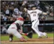  ?? MATT YORK — THE ASSOCIATED PRESS ?? The Diamondbac­ks’ Jake Lamb (22) scores on a base hit by Daniel Descalso (3) as Phillies catcher Andrew Knapp (34) awaits the throw during the third inning Monday in Phoenix.