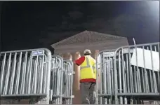  ?? STEFANI REYNOLDS / AFP ?? Workers set up fencing outside the US Supreme Court in Washington, DC, on Wednesday, as emotions run high following a leaked draft related to abortion.