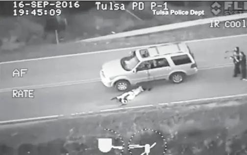  ??  ?? IMEJ pegun hasil rakaman video Jabatan Polis Tulsa menunjukka­n Crutcher terlentang di atas jalan raya dengan bahagian abdomen berlumuran darah selepas ditembak polis dalam insiden di Tulsa pada Jumaat minggu lepas. — Gambar Reuters