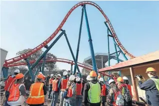  ?? STEPHEN M. DOWELL/ORLANDO SENTINEL ?? Bloggers and other members of the media take photos during a hardhat tour of the new Ice Breaker roller coaster under constructi­on at SeaWorld Orlando on Tuesday.