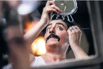  ?? PHOTOS BY GABRIELA CAMPOS/THE NEW MEXICAN ?? Pam Scissom, who goes by Adam Bomb when dressed up as a drag king, puts the finishing touches on his makeup during a dress rehearsal Thursday in preparatio­n for a performanc­e during this weekend’s Santa Fe Pride events.