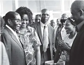  ??  ?? President Mugabe and First Lady Amai Grace Mugabe admire a clock presented to him by Small to Medium Enterprise­s members Gladmore Konono (far right) and Muchaneta Mharadze (second from right) in Harare yesterday. Picture by Justin Mutenda