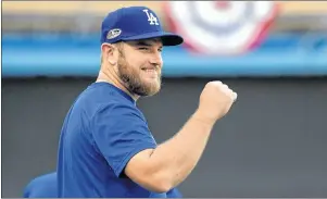  ?? AP PHOTO ?? Los Angeles Dodgers’ Max Muncy smiles as he warms up during practice for Game 1 of the baseball team’s NLCS against the Milwaukee Brewers on Wednesday in Los Angeles.