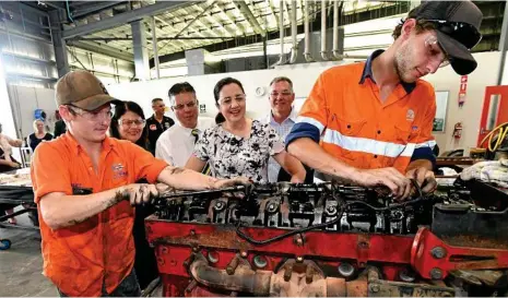  ?? PHOTO: DARREN ENGLAND/AAP ?? ASSEMBLY LINE: Premier Annastacia Palaszczuk (centre) speaks to trainees at the Townsville Trade Training Centre, where she announced regional employers would receive up to $20,000 in support payments for every eligible job seeker they recruit.