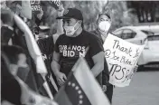  ?? DANIEL A. VARELA dvarela@miamiheral­d.com ?? In Doral, in front of El Arepazo at 10191 NW 58th St., crowds on Tuesday wave the Venezuelan flag and hold up signs thanking President Joe Biden. They were celebratin­g the approval of TPS for more than 300,000 Venezuelan citizens living in the United States.