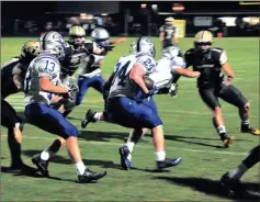  ?? File-FRANK CROWE / For the Calhoun Times ?? Gordon Central’s Branson Towe (24) looks for running lanes as his teammates block during last Friday’s game at Pepperell.