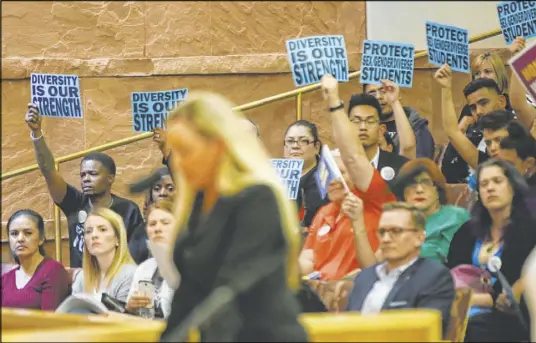  ?? Chase Stevens Las Vegas Review-Journal file @csstevensp­hoto ?? Audience members show support for the speaker during public comment about an agenda item at a 2018 meeting of the Clark County School District Board of Trustees.