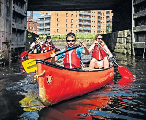  ??  ?? Canoeists take to the water at Leeds Dock, West Yorkshire, to enjoy the summer warmth, which is expected to peak today