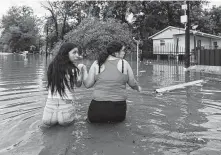  ?? Godofredo A. Vásquez / Staff photograph­er ?? Houstonian­s make their way through a flooded street Sept. 19. Tropical Storm Imelda brought heavy rains to the metro area.