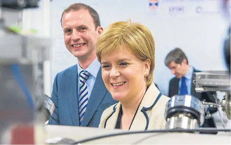  ?? Picture: Steven Brown. ?? First Minister Nicola Sturgeon and candidate Stephen Gethins at Andrews University being shown a molecular beam epitaxy machine that harnesses the properties of complex materials.