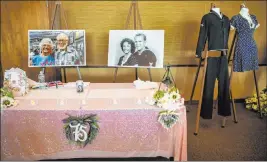  ?? L.E. Baskow Las Vegas Review-journal @Left_eye_images ?? Photos of Gail and Donna Andress and their wedding outfits on display during a renewal of vows ceremony celebratin­g their 75th wedding anniversar­y presented by Pioneering Las Vegas History and the Nevada State Museum on Tuesday.