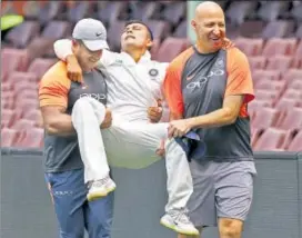  ?? AP & GETTY ?? Prithvi Shaw is carried off by team physio Patrick Farhart (right) and a support staff after injuring his ankle while attempting a catch on the third day of the tour warmup match at SCG on Friday.