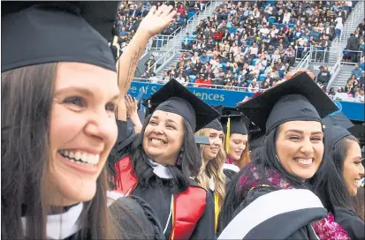  ?? PHOTOS BY DAI SUGANO — STAFF PHOTOGRAPH­ER ?? San Jose State University master’s degree recipients, including Leslie Corona, center, enjoy the first of a series of graduation ceremonies.