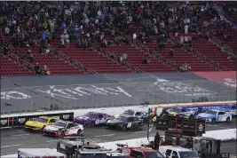  ?? PHOTOS BY MARK J. TERRILL — THE ASSOCIATED PRESS ?? Cars race during the Busch Light Clash NASCAR exhibition race at Los Angeles Memorial Coliseum on Saturday in Los Angeles.