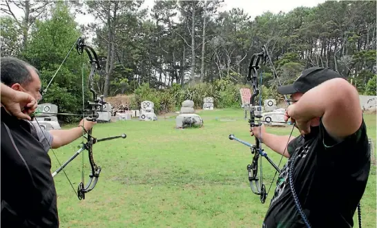  ??  ?? Captain Dean Sheerin and Travis Gamble practise field archery.