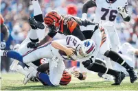  ?? ADRIAN KRAUS THE ASSOCIATED PRESS ?? The Bills’ Josh Allen, tackled by the Bengals‘ Carl Lawson and Carlos Dunlap, was sacked for more yards than he had passing.