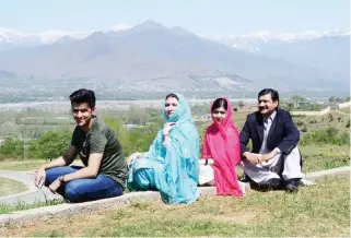  ??  ?? Malala Yousafzai with her father Ziauddin Yousafzai, right, mother Toor Pekai and brother Atal Yousafzai during her hometown visit on Saturday. (AFP)