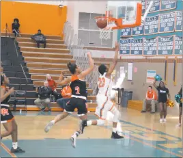  ?? STAFF PHOTOS BY CHARLIE WRIGHT ?? Westlake’s Latavia Washington finishes a layup ahead of Oakland Mills’ Marley Grenway after a steal in the fourth quarter of Saturday’s Class 2A South Region title game. The basket cut the Wolverines’ deficit to seven, but they would not get closer...