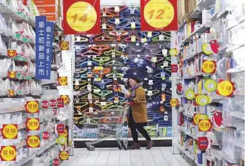  ?? Reuters ?? A customer at a hypermarke­t in Beijing. China published first-quarter growth in gross domestic product (GDP) at 6.8 per cent, driven by strong domestic consumer demand.