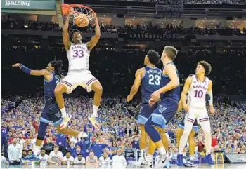  ?? BRYNN ANDERSON AP ?? Kansas’ David Mccormack (33) dunks the ball against Villanova’s Brandon Slater in the second half.