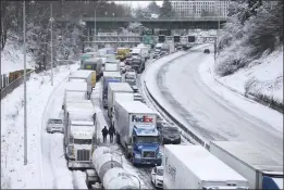  ?? DAVE KILLEN — THE OREGONIAN VIA AP ?? The backup of cars and trucks stuck on Interstate 84is seen from the Blumenauer Bicycle and Pedestrian Bridge in northeast Portland, Ore., on Thursday.