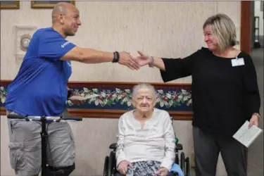  ?? ERIC BONZAR — THE MORNING JOURNAL ?? Life Enrichment Director Koreen Brattoli presents retired Avon police Officer and Lorain County Blue Foundation Vice President Pete Soto with a donation of $215 on behalf of staff and residents of Sprenger Health Care Autumn Aegis Retirement Community,...
