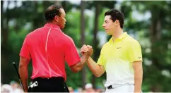  ??  ?? Former world number one golfers, Tiger Woods (L) of the United States and Rory McIlroy of Northern Ireland shake hands