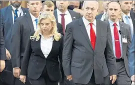  ?? Zoltan Mathe MTI ?? BENJAMIN NETANYAHU, with his wife, Sara, is accused of offering regulatory favors to a telecommun­ications giant in exchange for positive news coverage.
