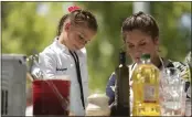  ?? STAFF FILE PHOTO ?? Six-year-old Addyson Dell, left, cooks garlic macaroni and cheese with garlic chicken tenders and roasted asparagus in last year’s Garlic Chef Jr. contest.