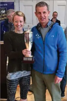  ??  ?? Mary Leech receives the winners cup for the third time at the BHAA 10K Road Race.