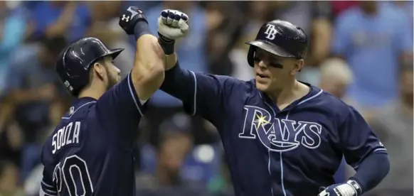  ?? CHRIS O’MEARA/THE ASSOCIATED PRESS ?? Tampa Bay’s Logan Morrison, right, celebratin­g with Steven Souza Jr., hit one of two homers off Marco Estrada on Saturday. Former Blue Jay Colby Rasmus had the other.